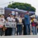 Under the rain and with threats of sabotage, workers deliver petitions to the US Embassy for decent wages