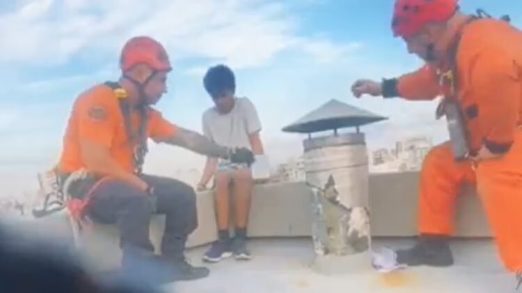 Firefighters saved a young man who sat on a ledge and threatened to jump from the 13th floor
