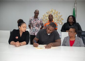 Housing beneficiaries at Bellevue Chopin sign documents for issuance of certificates of title