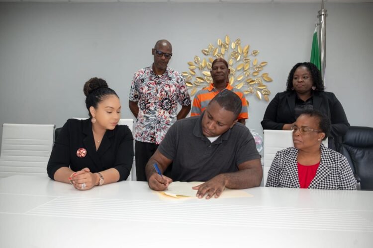 Housing beneficiaries at Bellevue Chopin sign documents for issuance of certificates of title