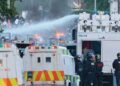Violence against migrants brings Northern Ireland back to ‘the darkest chapters of its past’