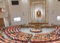 “The citizen is never cut off from the loaf of bread.” How did a heated government parliamentary debate at the “Economy of Representatives” table end with a consensus proposal?