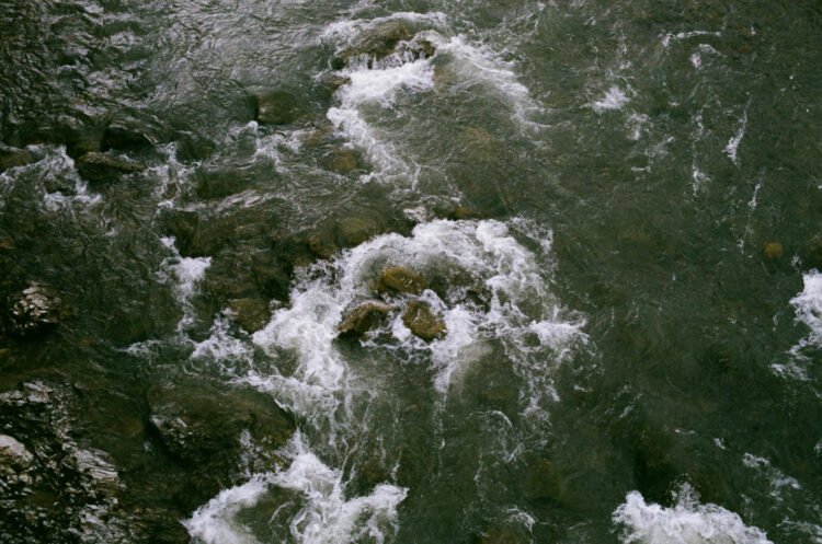 A dead boy is found by the river; a towel tied around his neck