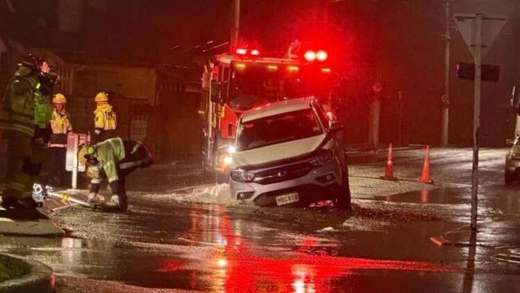 Video shows water bursting from broken pipe after sinkhole opens and swallows ute