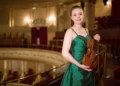 A young musician with a violin that is more than three centuries old