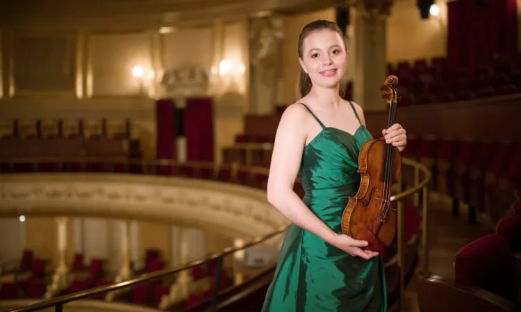 A young musician with a violin that is more than three centuries old