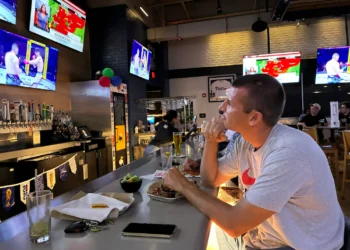 At a UFC watch party, cheers for the fight and dismay over the war in Iran