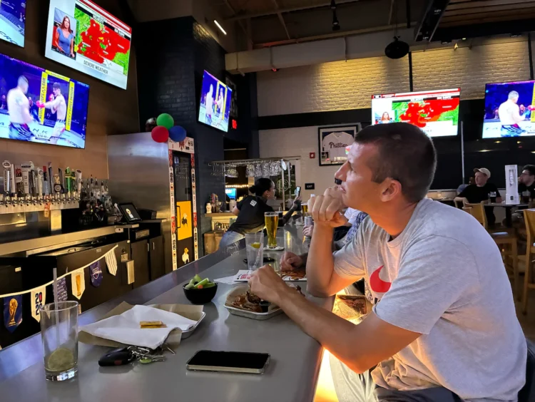 At a UFC watch party, cheers for the fight and dismay over the war in Iran