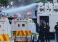 Belfast, Northern Ireland: Police fire water cannon on second night of as anti-immigrant protests