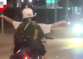 Foreigner has motorcycle confiscated for riding hands-free in ‘flying bird’ pose in Da Nang