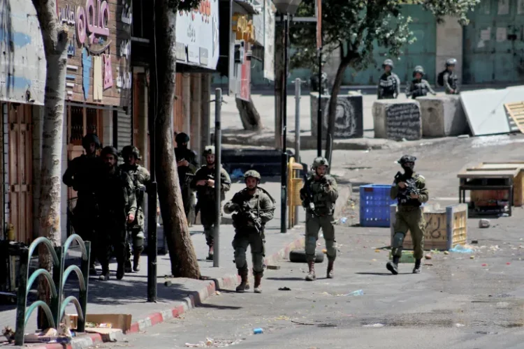 Israeli forces detain Palestinians in West Bank as settler attacks escalate