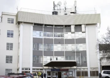 Man charged after walking into hospital with a gun