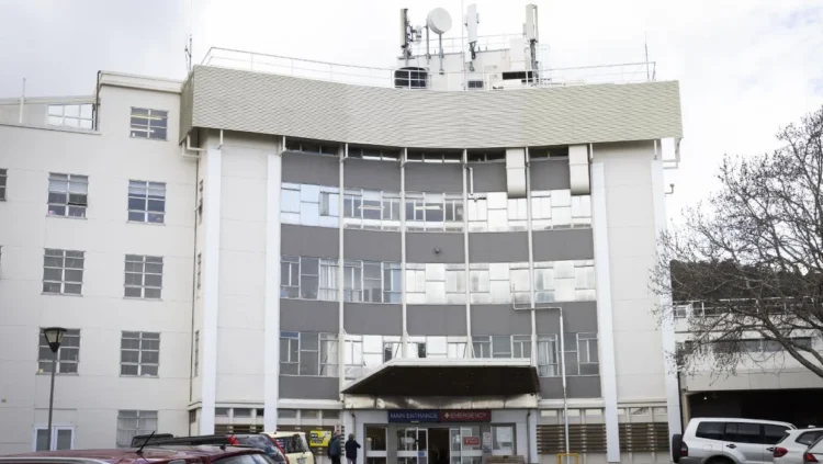Man charged after walking into hospital with a gun