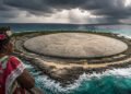 The United States buries more than 100,000 cubic yards of radioactive waste in an unlined crater, covers everything with concrete in the Pacific, and leaves residents of the Marshall Islands concerned about the rising sea.