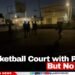 A Basketball Court with Players But No Lights