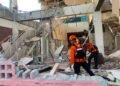 Rescuers dig through rubble and landslides after Indonesia quake kills 53