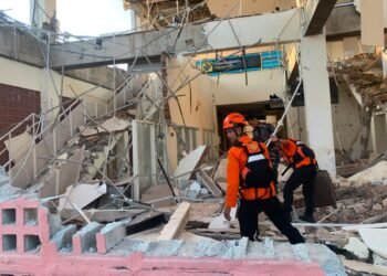 Rescuers dig through rubble and landslides after Indonesia quake kills 53