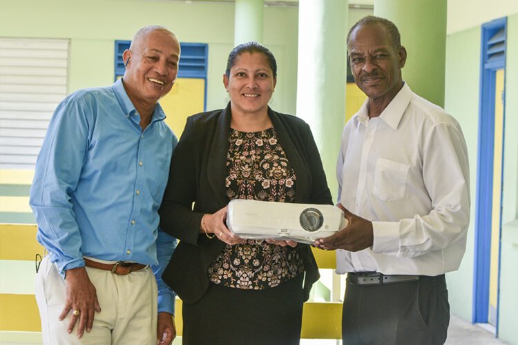 SVG EX Teachers present movie projector to J.P Eustace Memorial