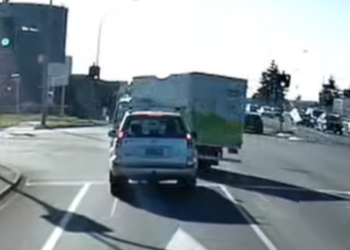 Dashcam shows company truck cutting through traffic at intersection