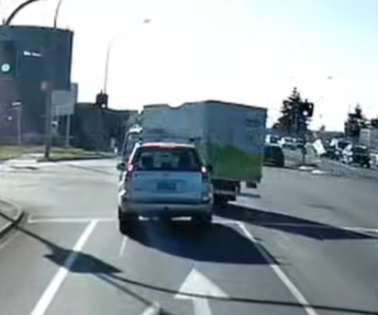 Dashcam shows company truck cutting through traffic at intersection