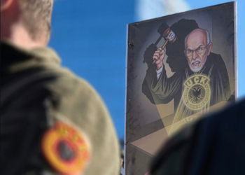 Banner of a protesting citizen: Chief Justice Charles Smith under the silhouette of Albin Kurti, with EU hammer in hand