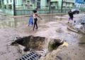 Photo of the day: A huge pothole becomes a waterfall and a trap for passers-by