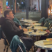 Watch: Blasé French couple smoke and drink while riots rage outside