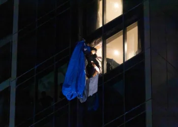 Video shows dramatic moment rescuers smash 23rd floor window and haul BASE jumper to safety