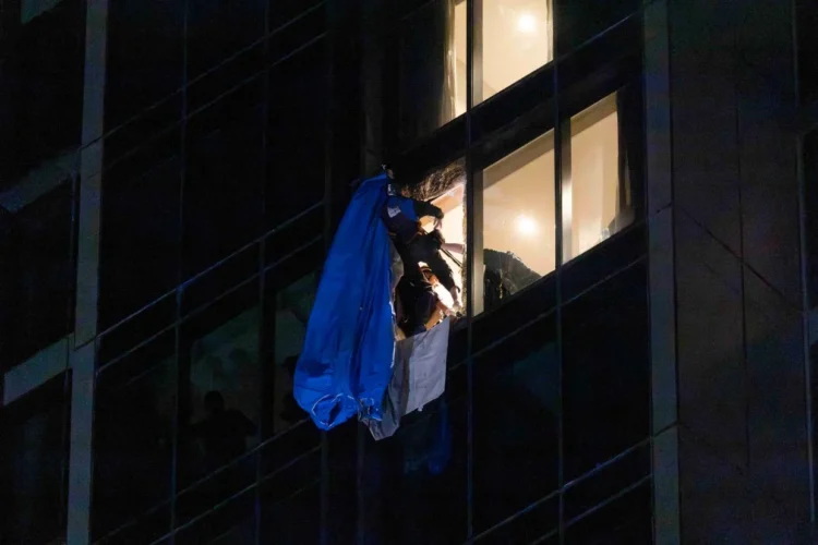 Video shows dramatic moment rescuers smash 23rd floor window and haul BASE jumper to safety