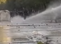 View of how the great pressure of the water from the autobot knocks the protester to the ground in Tirana
