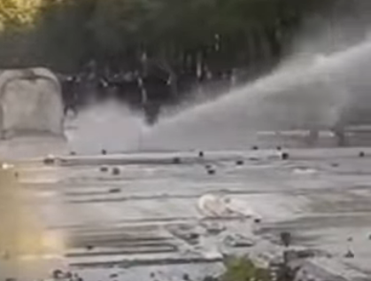 View of how the great pressure of the water from the autobot knocks the protester to the ground in Tirana